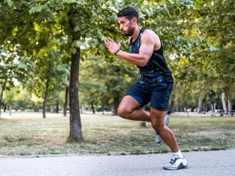 Man running on trail at park.