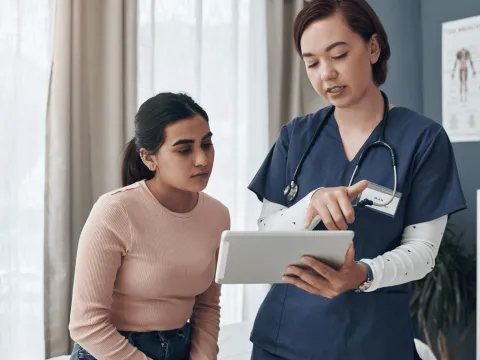 A Doctor Goes Over a Chart with her Patient.