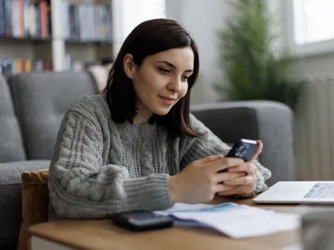A young woman looking at her phone.