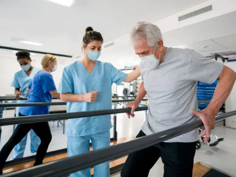 Nurse Helping Patient with Rehabilitation Exercise