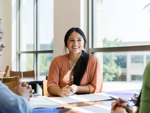 Hispanic Girl Smiling at Other Students