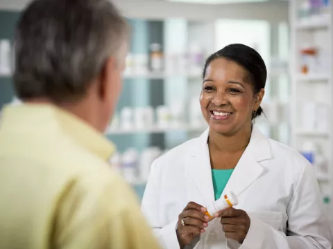 Pharmacist Smiling at Customer