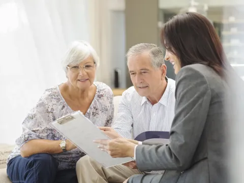 Senior couple talking to financial advisor.