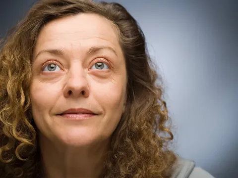 Woman looking up smiling.