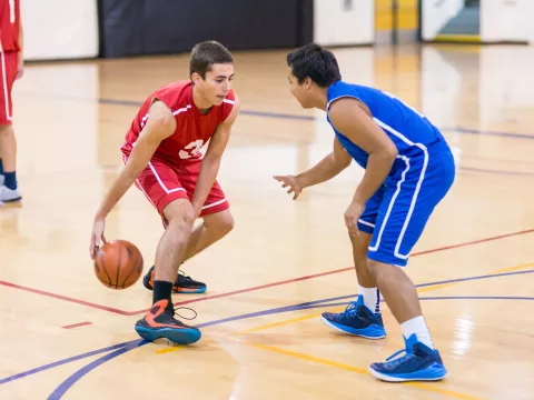 Two Teens Playing Indoor Basketball