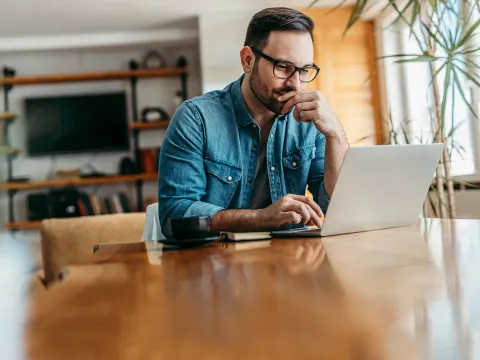 A man doing research on a laptop.