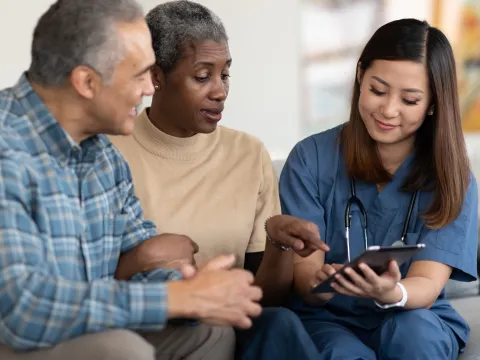 An older couple reviews their test results with their doctor.