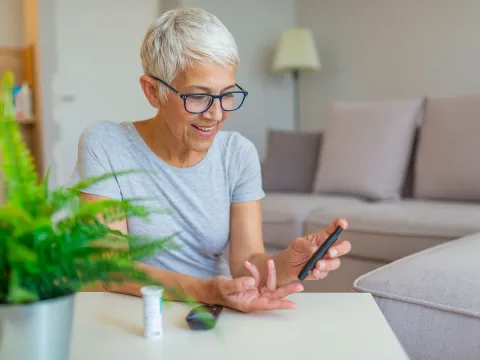 Woman checking blood sugar.