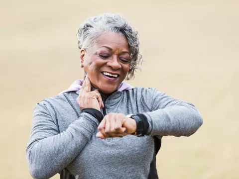 Female runner checking her wearable device