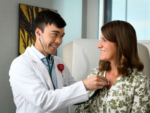 Doctor checking patient's heart.