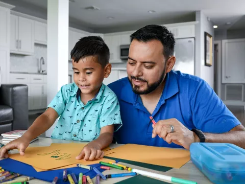 Man with his son coloring