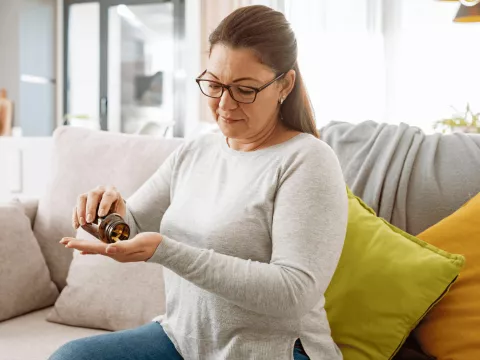 A woman taking her medication.