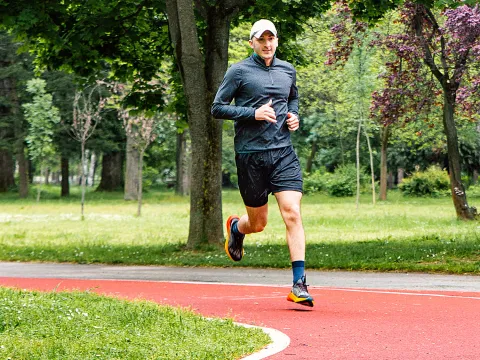 Man running outdoors at park.
