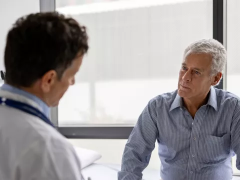 .Older Man talking his doctor about Aquablation.