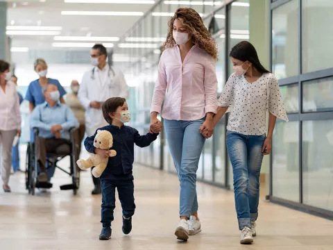 Mother, son and daughter leaving the emergency room.