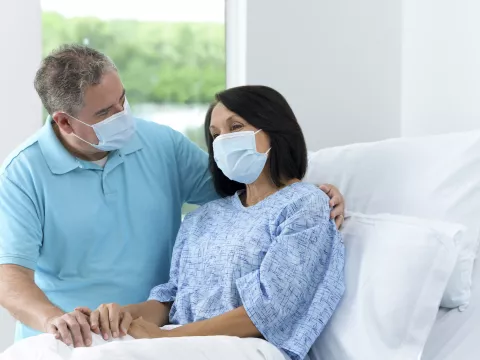 Patient with Family visitor in hospital bed