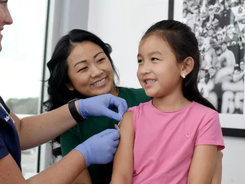 A Nurse Puts a Band Aid on a Child Patient after an Injection