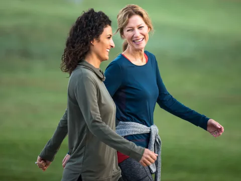 Two Women Walking and Smiling