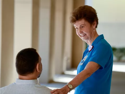Volunteer Helping Patient