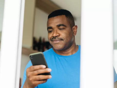 Man reading iPhone 