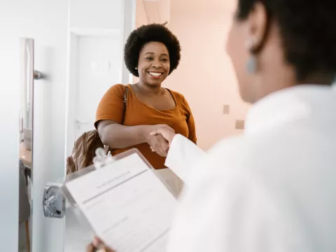 Woman shaking her doctor's hand.