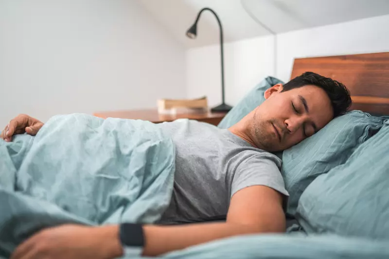 A Man Sleeps in His Bed at Home
