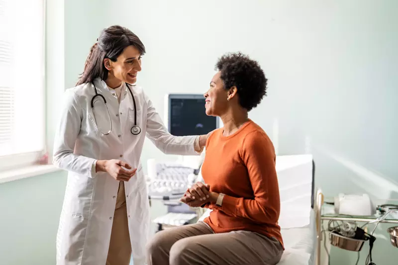 A Provider Speaks to a Patient in an Exam Room