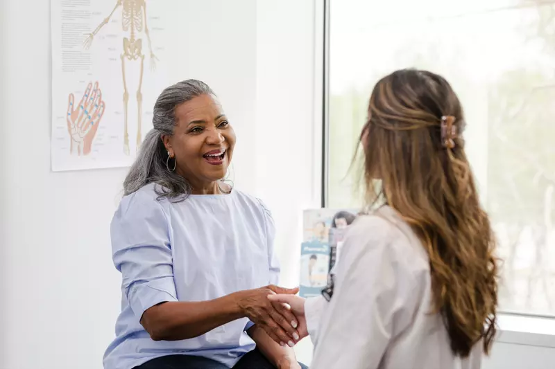 A Patient Greets a Provider in an Exam Room