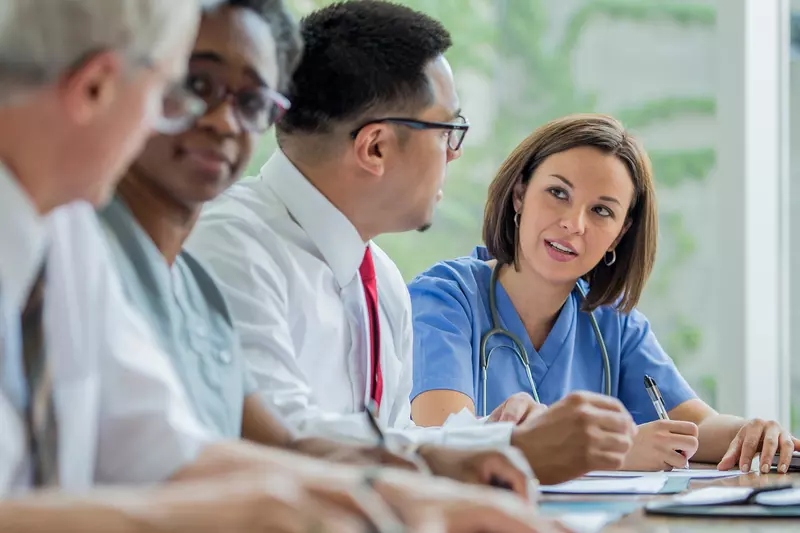 A Resident speaks with Hospital Staff