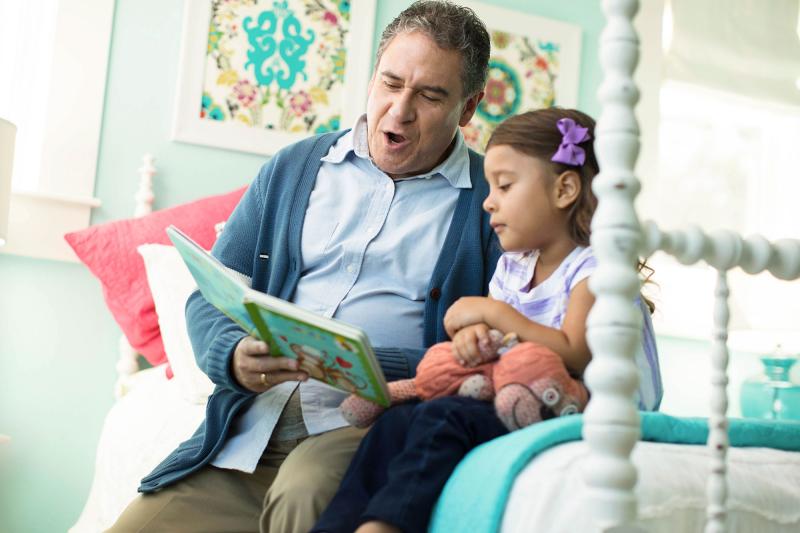 Grandpa Reading to Little Girl