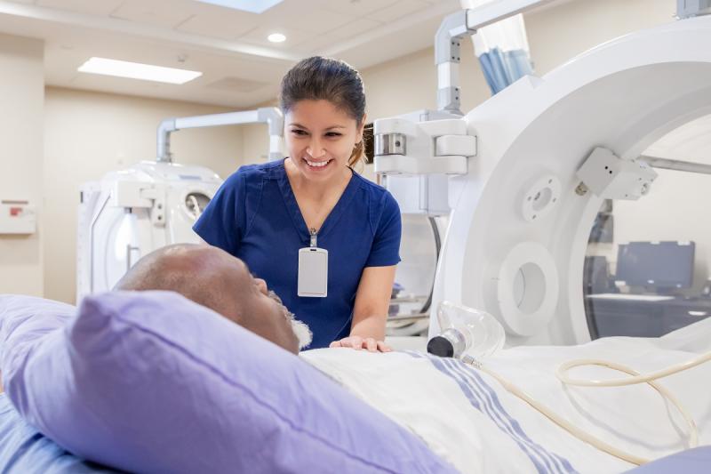 Nurse prepping patient for treatment in Hyperbaric Chamber