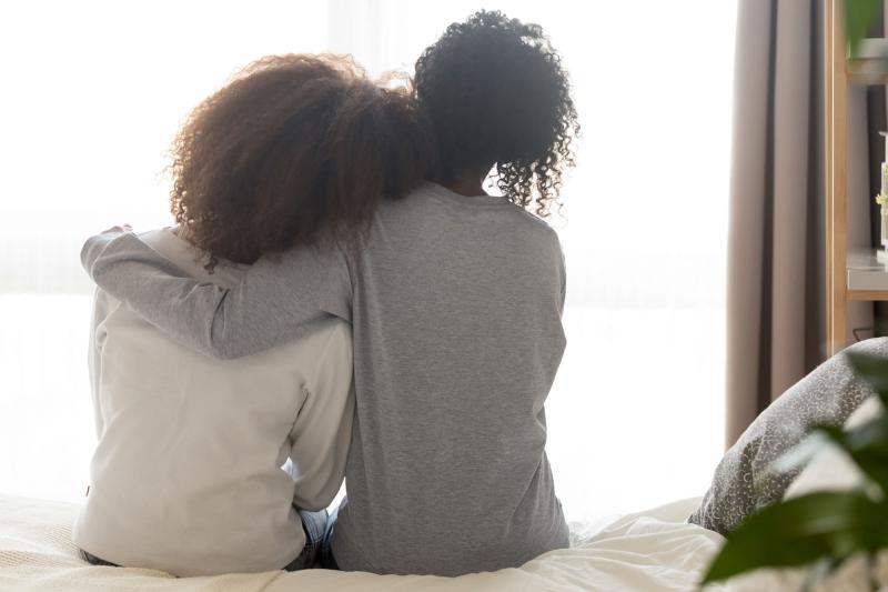 Woman comforting teenage child
