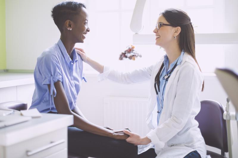 Woman getting her checkup with Primary Care Doctor