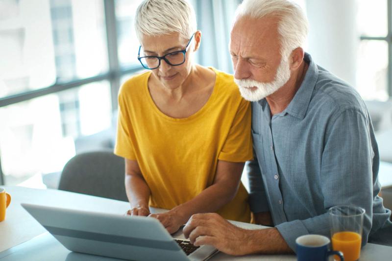 Older couple looking at computer screen in living room