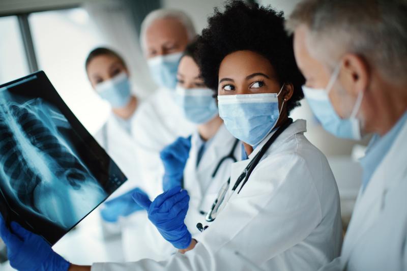 Doctors reviewing scans for patient with other doctors