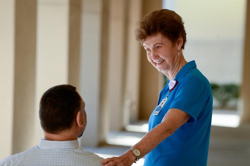 Volunteer Helping Patient