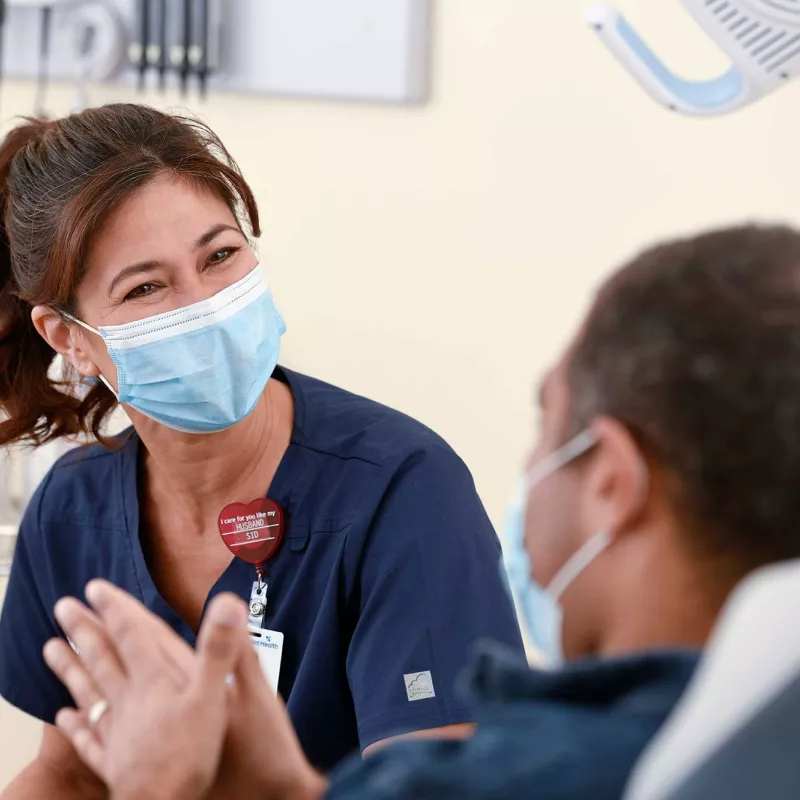 Physican Talking to Patient with Masks on