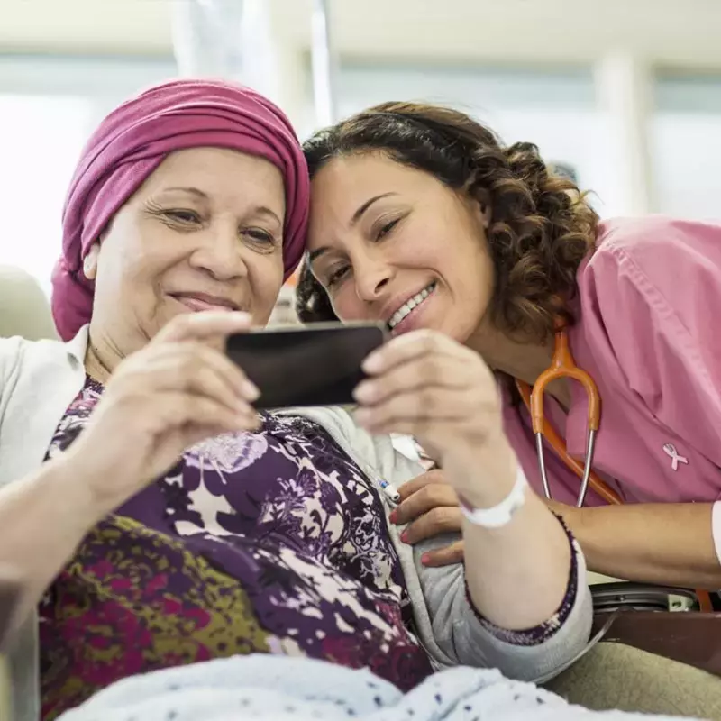 Female Volunteer spending time with female cancer patient