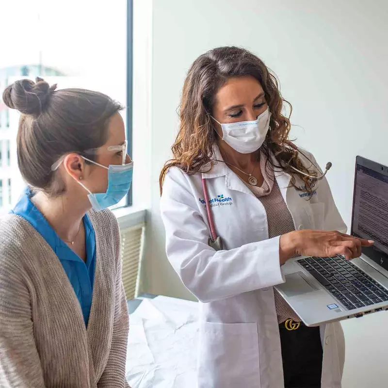 Physician Showing Patient Something on a Laptop
