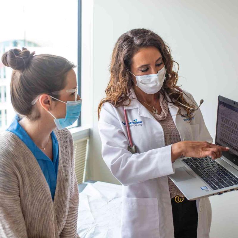 Physician Showing Patient Something on a Laptop