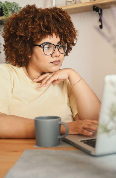 Woman on Laptop Checking Bills
