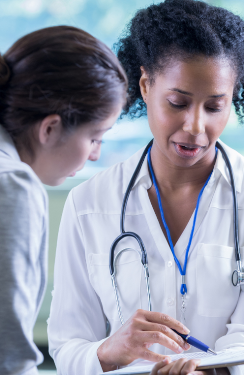 A Physician Goes Over A Chart With Her Patient