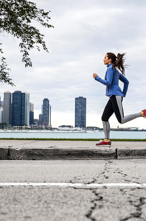  Woman running with Chicago city in Background