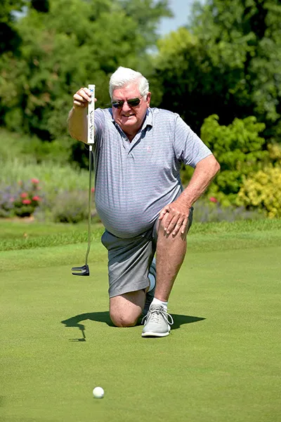 John Brockob Kneeling in Front of Putt
